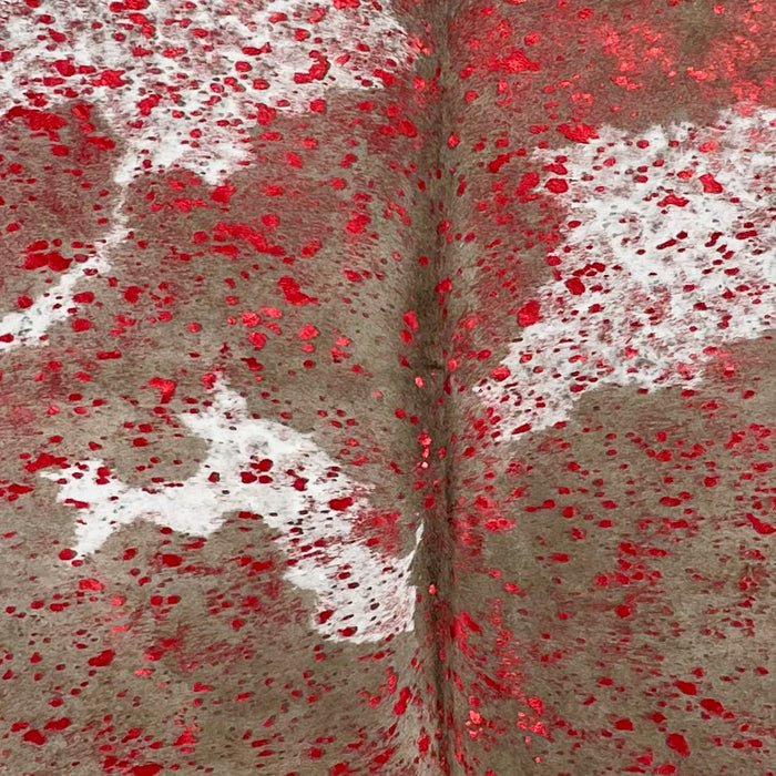 Closeup of this Brown and White, Colombian Cowhide, showing a red, metallic acid wash  (COAW434)