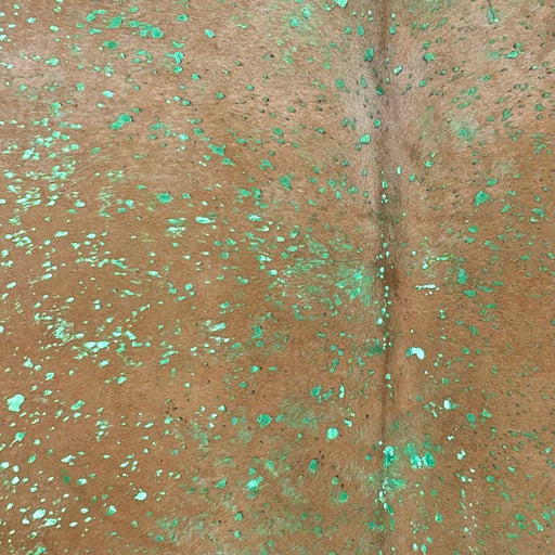 Closeup of this Light Brown, Colombian Cowhide, showing a green, metallic acid wash  (COAW438)