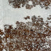 Closeup of this Tricolor, Colombian Cowhide, showing white with brown and black spots, and  a silver, metallic acid wash (COAW447)