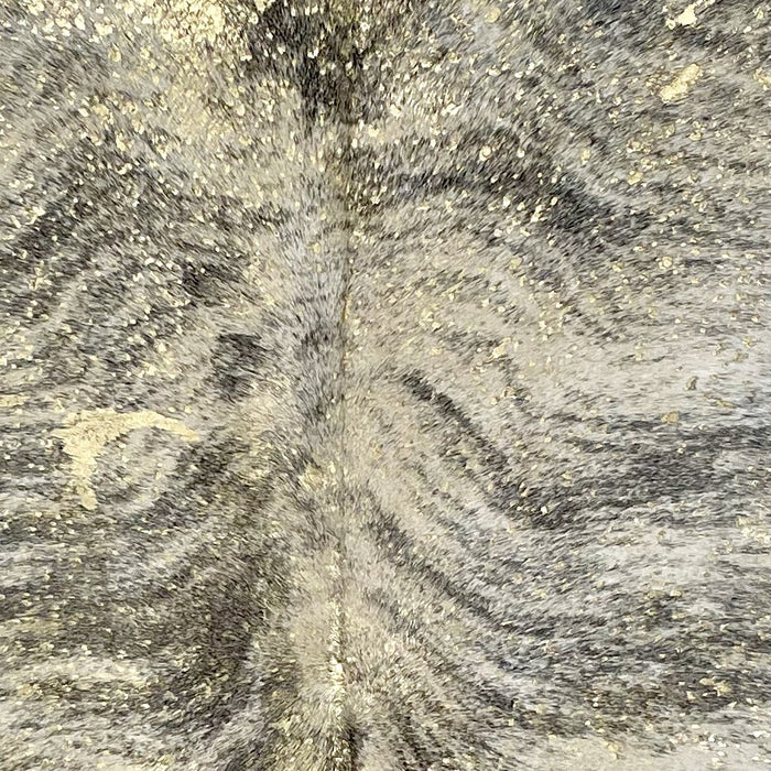 Closeup of this Colombian Brindle Cowhide, showing white with black, brindle markings, and a gold, metallic acid wash (COAW453)