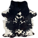 Black and White Colombian Cowhide: white with large and small, black spots, and some having hints of dark brown mixed in with the black - 7'5" x 5'6" (COBKW277)