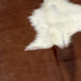 Closeup of this Brown and White, Colombian Cowhide, showing brown, and one of two large, white spots in the middle (COBNW322)