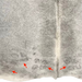 Closeup of this Two Tone Gray Colombian Cowhide, showing four brand marks on the butt (COGR319)