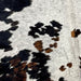 Closeup of this Tricolor, Speckled, Colombian Cowhide, showing white with black speckles, and spots that are black and brown (COSP1941)