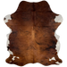 Colombian Tricolor Cowhide:  has a reddish brown and black, brindle pattern, with white on the belly and part of the shanks - 7'2" x 5'5" (COTR1005)