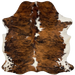 Colombian Tricolor Cowhide:  has a brown and black, brindle pattern, with a few white spots on the back and down the spine, and it has white, with brown and black spots on the belly and shanks - 6' x 5' (COTR1024)