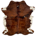 Colombian Tricolor Cowhide:  has a mix of brown and black covering most of the hide, with four small, white spots, and white with brown spots and speckles on the belly and part of the shanks - 6'7" x 5' (COTR1036)