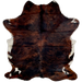 Colombian Dark Tricolor Cowhide:  has long hair that has mix of black and reddish brown covering most of the hide, and white spots on the belly and shanks - 6'8" x 5' (COTR1037)