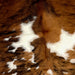 Closeup of this Colombian, Tricolor Cowhide, showing white with large and small spots that have a brown and black, and dark reddish brown and black, brindle pattern (COTR1038)