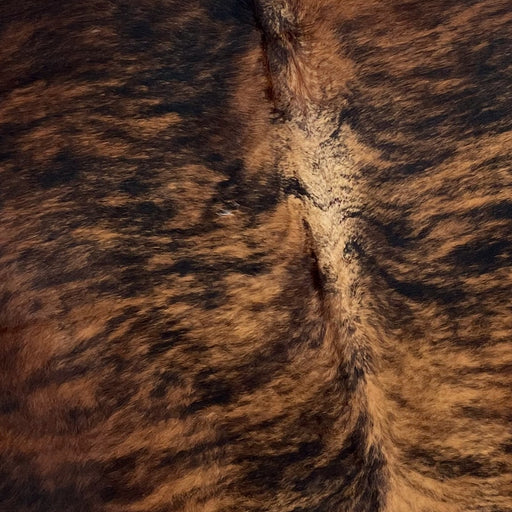Closeup of this Colombian Tricolor Cowhide, showing a brown and black, brindle pattern (COTR1059)