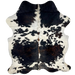 Colombian Tricolor Cowhide:  white, with some small and large, black spots, , a few small, brown spots on the spine, some faint, black speckles, and two large spots on the back that have a mix of black and brown with white speckles - 6'2" x 4'10" (COTR1067)