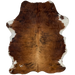 Colombian Tricolor Cowhide:  mostly brown, with some black, brindle markings down the middle, and it has white on part of the belly and shanks, and longer hair on the shoulder and belly - 6'2" x 4'8" (COTR1073)