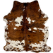 Colombian Tricolor Cowhide:  has a reddish brown and black, brindle pattern, and large and small white spots that have brown speckles and spots - 7'2" x 5'8" (COTR1120)