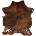 Colombian Tricolor Cowhide, long hair:has long hair that has a reddish brown and black, brindle pattern, and a couple of white spots that have brown and black speckles - 6'7" x 5' (COTR1126)