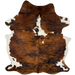 Large Colombian Tricolor Cowhide:  has a reddish brown and black, brindle pattern, with a few white spots in the middle of the shoulder, and white on the belly and part of the shanks - 7'6" x 5'9" (COTR1173)