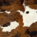 Closeup of this Colombian Tricolor Cowhide, showing white with black speckles, and large and small spots with a brown and black, brindle pattern (COTR1268)