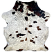 Colombian Speckled Tricolor Cowhide: white and off-white, with faint, cloudy brown and black speckles, and it has a few large and small spots with a mix of black and brown, and it has long hair down part of the spine - 7' x 5'9" (COTR1276)