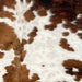 Closeup of this Colombian Tricolor Cowhide, showing white with spots that have a mix of brown and black, and faint, cloudy, brown spots (COTR1289)