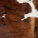 Closeup of this Colombian Tricolor Cowhide, showing a reddish brown and black, brindle pattern, and small and large, white spots  (COTR1328)