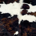 Closeup of this XL Colombian Tricolor Cowhide, showing white with large and small spots that have a black and dark brown, brindle pattern (COTR1396)