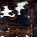 Closeup of this Colombian Tricolor Cowhide, showing white with black speckles, and small and large spots that have a black and reddish brown, brindle pattern  (COTR1449)