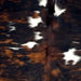 Closeup of this Colombian Tricolor Cowhide, showing a black and reddish brown, brindle pattern, with small, white spots on the back (COTR1460)
