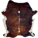 Colombian Tricolor Cowhide: has a reddish brown and black, brindle pattern, a couple white spots on the spine, and off-white on the belly and part of the shanks - 7'4" x 5'4" (COTR1470)