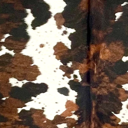 Closeup of this Large Tricolor Speckled Colombian Cowhide, showing white with brown and black speckles, and large and small spots that have a mix of black and reddish brown - 7'9" x 6' (COTR1479)