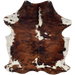 Colombian Tricolor Cowhide: has a reddish brown and black, brindle pattern, a few white spots down the middle, white on the belly and part of the shanks, and longer hair down the spine - 6'2" x 4'9" (COTR1504)