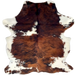 Colombian Tricolor Cowhide: has long hair that has a mix of reddish brown and black, with a few white spots, and white on the belly and shanks - 6'10" x 5'3" (COTR1542)