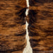Closeup of this Large Colombian Tricolor Cowhide, showing a reddish brown and black, brindle pattern, and off-white with black speckles down the spine  (COTR1552)