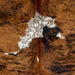 Closeup of this Colombian Tricolor Cowhide, showing a reddish brown and black brindle pattern, and white spots with black speckles (COTR1578)
