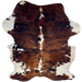 Colombian Tricolor Cowhide: has a reddish brown and black, brindle pattern, with white spots on the back, belly, and shanks, and longer hair down part of the spine and on the belly - 7'2' x 5'2" (COTR1642)