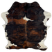Colombian Tricolor Cowhide:  has a black and reddish brown, brindle pattern, with a white spot in the middle of the shoulder, and white on the belly and shanks - 6'3" x 5'4" (COTR858)