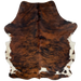 Colombian Tricolor Cowhide:  has a reddish brown and black, brindle pattern with a white spot on the right side, near the lower edge, and white with brown spots on the belly and part of the hind shanks - 6'5" x 4'10" (COTR874)