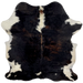 Colombian Dark Tricolor Cowhide:  mostly black, with some dark brown mixed in, off-white on part of the spine, a couple white spots near the lower edge, and off-white on the belly and part of the shanks - 6'5" x 4'11" (COTR884)