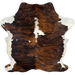 Colombian Tricolor Cowhide:  has a black and reddish brown, brindle pattern, with white in the middle of the shoulder, and a few small, white spots on the back, and white on the belly and part of the shanks - 6'9" x 5'3" (COTR917)