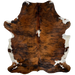 Colombian Tricolor Cowhide:  has a reddish brown and black, brindle pattern, with a white spot in the middle of the shoulder, and white on part of the belly and shanks - 7'2" x 5'5" (COTR924)