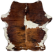 Colombian Tricolor Cowhide:  has a brown and black, brindle pattern, with a large off-white spot on the right side, and a few small off-white spots, and off-white with brown spots on the belly and shanks - 6'7"x x 5'2" (COTR936)