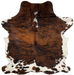 Colombian Tricolor Cowhide:  has a reddish brown and black, brindle pattern, with a few small, white spots along the spine on the shoulder, and it has white with brown and black spots on the belly, shanks, and butt - 7'2" x 5'5" (COTR939)