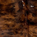Closeup of this Colombian, Tricolor Cowhide,  showing brown and black, with a few small, white spots in the middle (COTR941)
