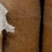 Closeup of this Goatskin, showing brown with dark brown down the spine and a small, white and dark brown speckled spot on the belly  (GOAT391)