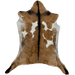 Brown and White Goatskin: brown with a couple white spots on both sides of the back, and a blackish brown strip across the shoulder and down the spine - 3' x 2'1" (GOAT399)