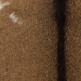 Closeup of this Goatskin, showing brown with blackish brown speckles and blackish brown down the spine, and two small white spots on then left side (GOAT463)