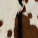 Closeup of this Goatskin, showing off-white with brown spots and black down the spine (GOAT474)
