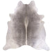 A natural grey cowhide rug shown from above on a white background.