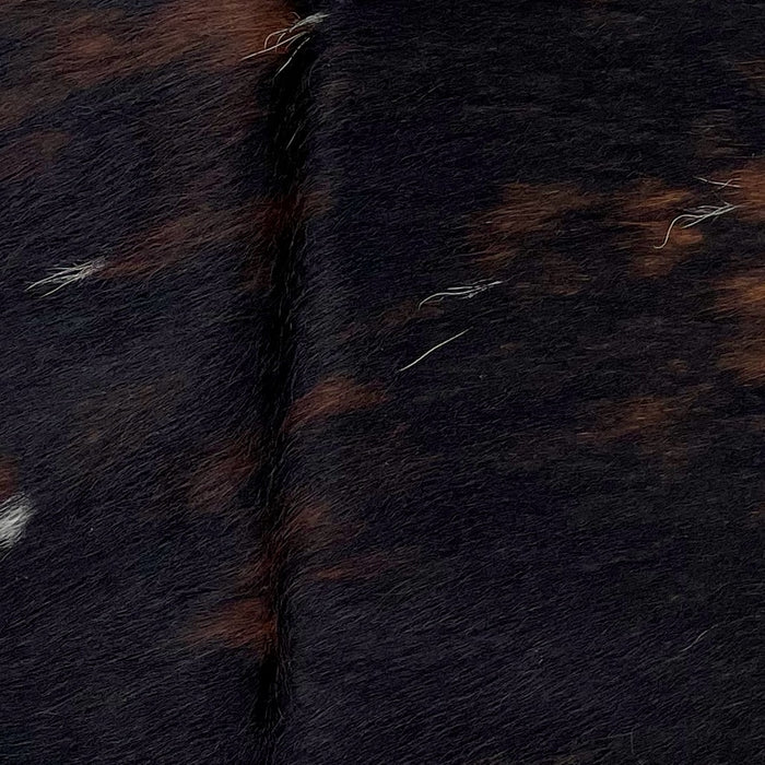 Closeup of this Dark Tricolor Mii Cowhide, showing a mix of black and reddish brown, and a few small, white speckles (MINI219)