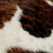Closeup of this Tricolor Mini Cowhide, showing a brown and black, brindle pattern, and white with black and brown speckles (MINI222)