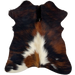 Tricolor Mini Cowhide:  has a mix of black and reddish brown, with an off-white spot in the middle of the bottom half, and on the left hind shank - 2'8" x 2'3" (MINI281)