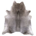 A natural grey cowhide rug shown flat against a white background.